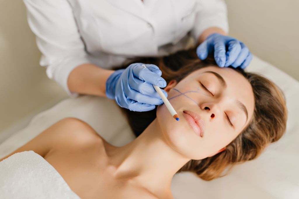 portrait-woman-with-brunette-hair-preparation-rejuvenation-cosmetology-operation-beauty-salon-hands-blue-gloves-drawing-face-botox-beauty